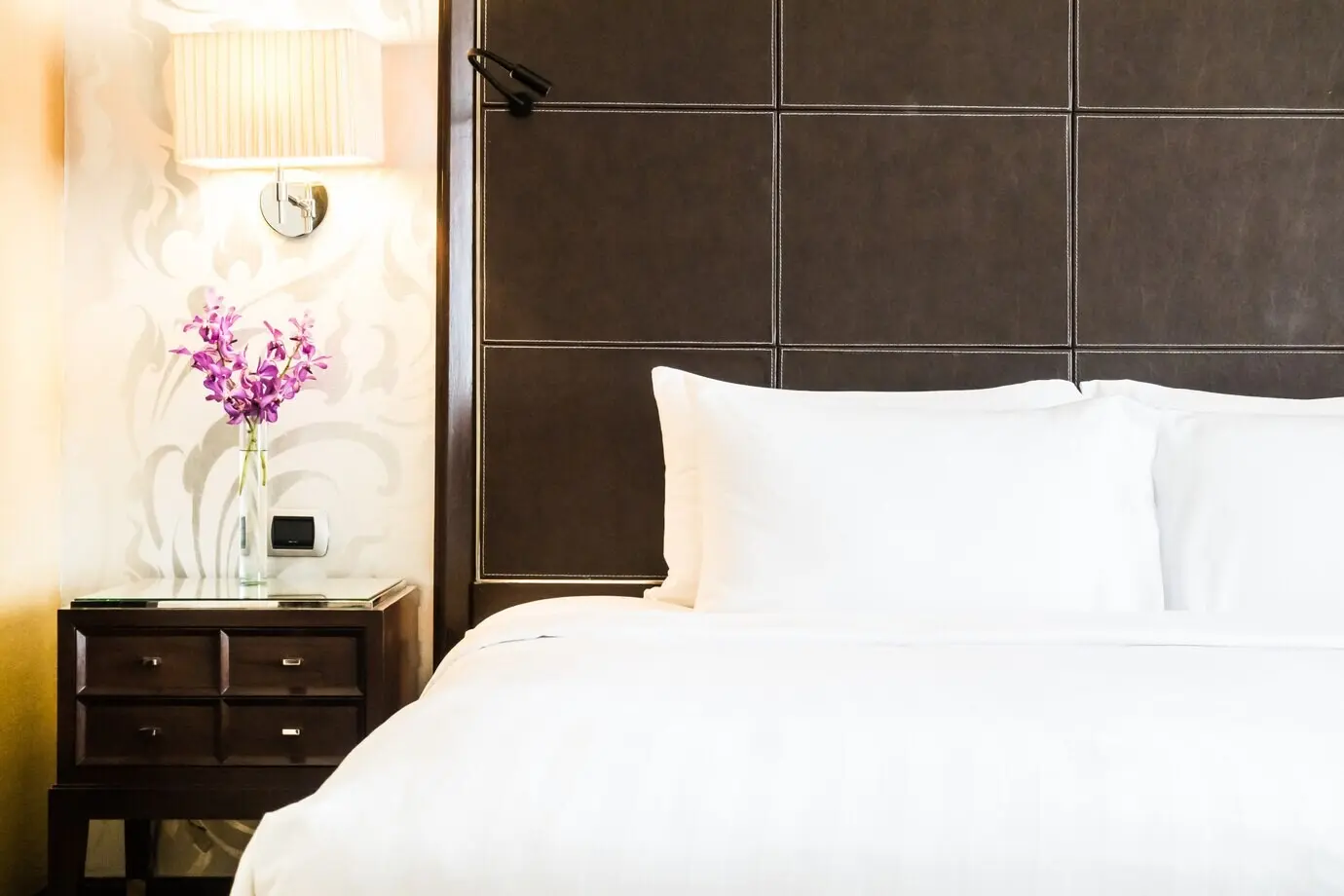 A white pillow on a bed